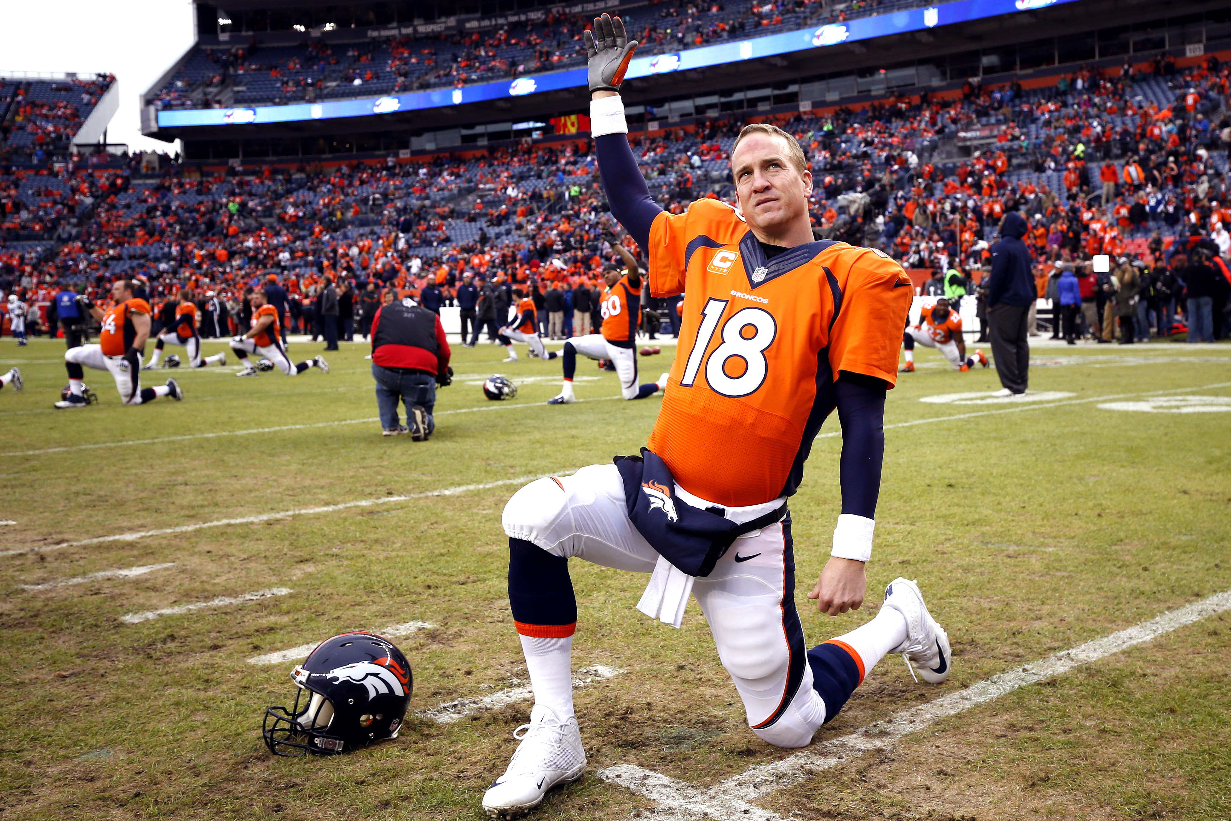 Denver Broncos quarterback Peyton Manning (18) stretches prior to an NFL divisional playoff football game against the Indianapolis Colts , Sunday, Jan. 11, 2015, in Denver. (AP Photo/Jack Dempsey)